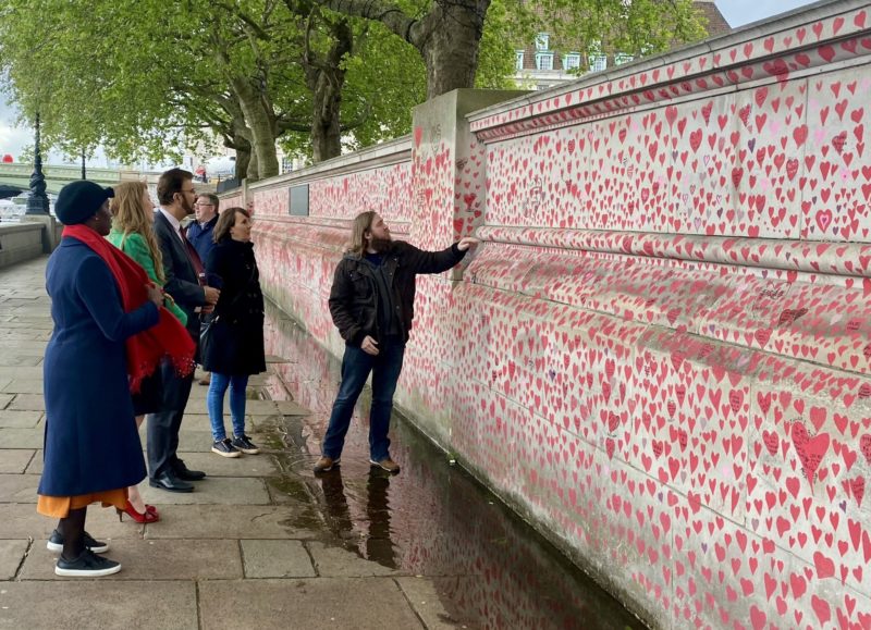 Angela is pictured at the Covid Memorial Wall with MPs Flo Eshalomi and Afzal Khan and a representative from Covid Justice UK.