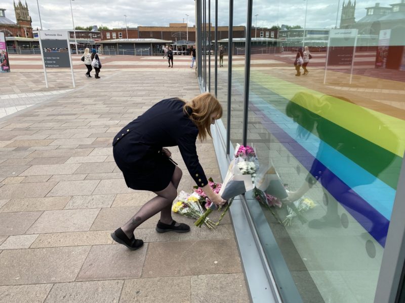 Angela lays flowers at Ashton Library