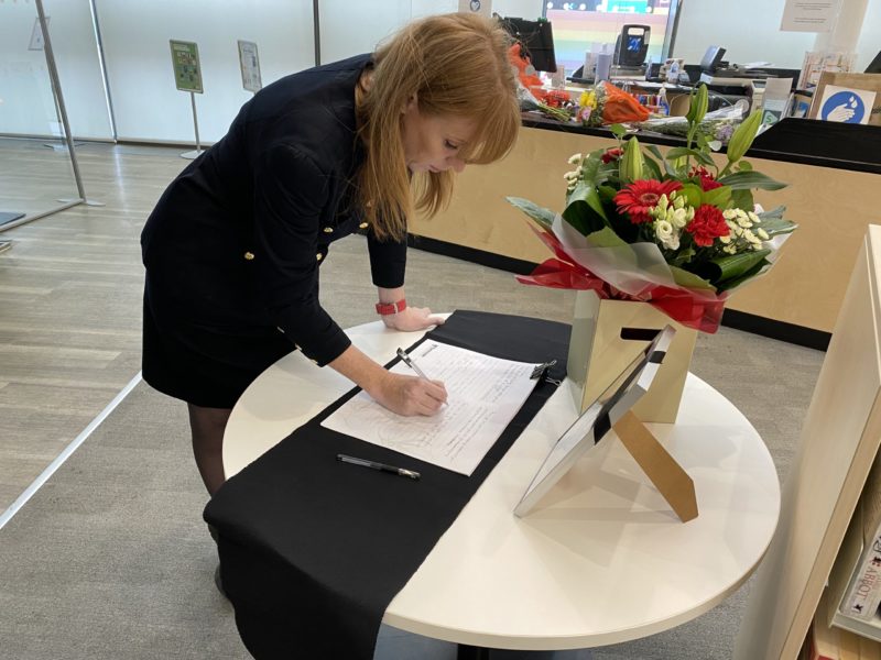 Angela signs the Book of Condolence